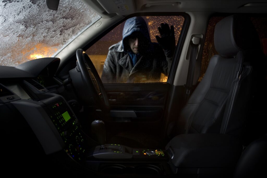 How to protect your classic car from theft in 2025 ? car thief looking into parked car high res stock photography 84873579 1530816861 1 How to protect your classic car from theft in 2025 ?